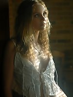 Blonde in frilly white under cloths and soft lights.